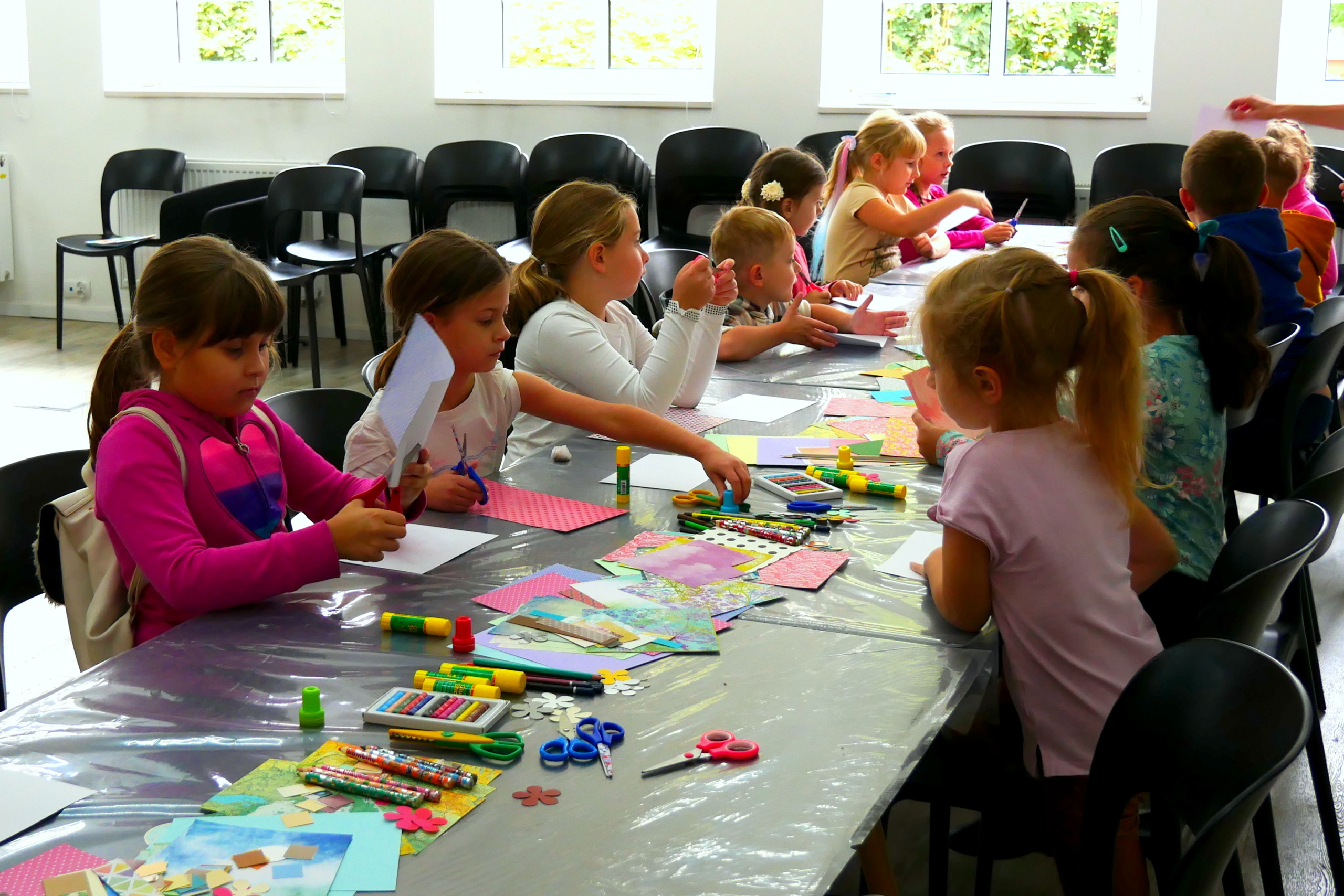 Dzieci rysują kolorowe pocztówki