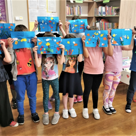 Dzieci prezentujące swoje prace plastyczne